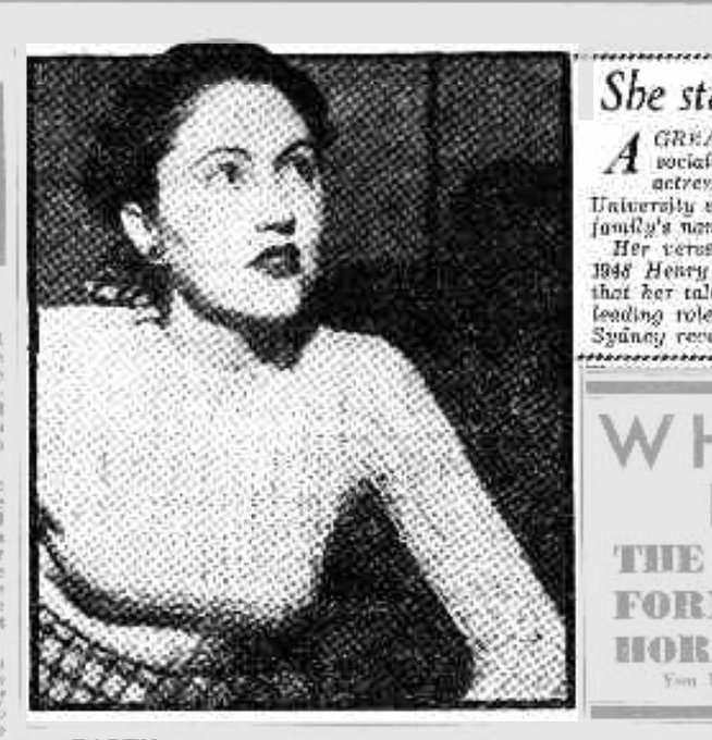 Screenshot of the photo attached to the 1949 newspaper article. A black and white photo of a young Coral Lansbury wearing a light-coloured knitted long sleeve top, a tartan skirt, dark lipstick and large stud earrings. Her dark hair is pulled back and her face is slightly turned as she looks up and to the side.